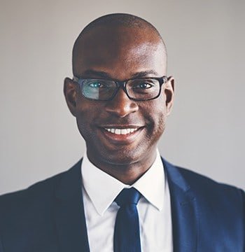 A person working on a laptop with abstract graphics in the background